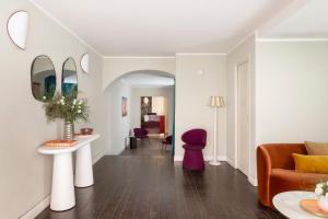 a living room with a couch and a table at Barberini Retreat Boutique Hotel in Rome