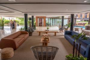a living room with a couch and a table at Afago Mareiro Hotel in Fortaleza +113 photos