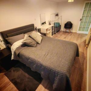 a bedroom with a bed with a pillow on it at Treforgan Newydd in Cardigan