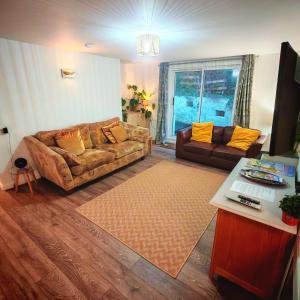 a living room with a couch and a table at Treforgan Newydd in Cardigan