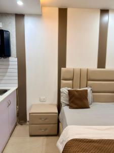 a hotel room with two beds and a tv at Halo Haven in Dehradun