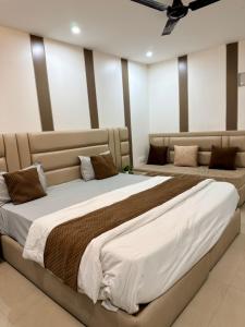a bedroom with two beds in a room at Halo Haven in Dehradun +4 photos