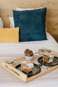 a tray with food on top of a bed at Le Nautica Hôtel in Perros-Guirec
