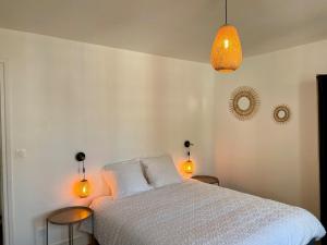 a bedroom with a bed with two tables and two lights at Bohemian Rhapsody- Hyper centre Compiègne in Compiègne