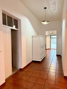 an empty room with a tile floor and a hallway at Fronteira in Fronteira
