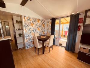 a dining room with a table and chairs at MH Camping la plage - MarieVa in Mimizan-Plage