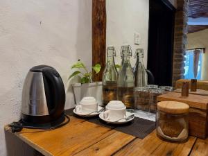 a table with a coffee maker and bottles on it at Bhanjyang Village Lodge in Pokhara +43 photos