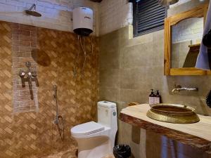 a bathroom with a toilet and a sink at Bhanjyang Village Lodge in Pokhara