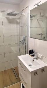 a white bathroom with a sink and a shower at DEBSI vacation rental in Bad Windsheim +9 photos