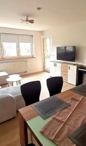 a living room with a couch and a table with chairs at DEBSI vacation rental in Bad Windsheim