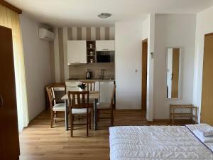 a bedroom with a bed and a table and chairs at Apartments & Rooms CASA GAGRO in Međugorje