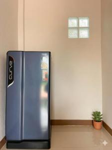 a stainless steel refrigerator in a room with a window at Yankoi Mountains view in Chiang Dao