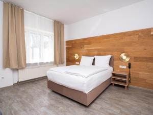 a bedroom with a large bed and a window at DONAUHOTEL Ingolstadt in Ingolstadt