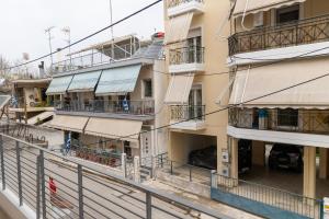an apartment building with balconies and a street at Pineios View New Apartment in Larisa