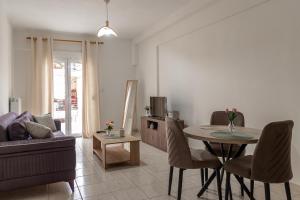 a living room with a table and a couch at Pineios View New Apartment in Larisa