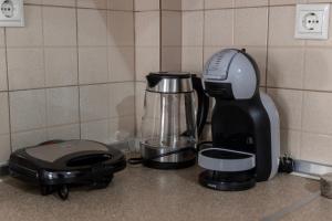 a kitchen counter with a coffee maker and a blender at Pineios View New Apartment in Larisa
