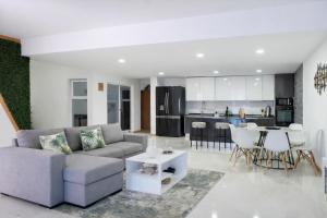 a living room and kitchen with a couch and a table at Salt & Sand T3 in Praia
