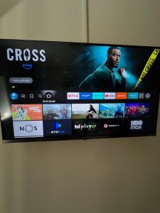 a flat screen tv hanging on a wall at Private Room in Old Town in Viana do Castelo