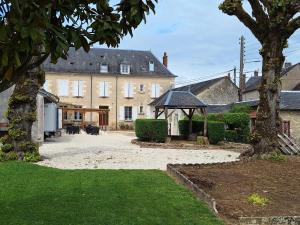 a large house with a gazebo in a yard at Au P'tit Gueul'ton in Les Aix-dʼAngillon