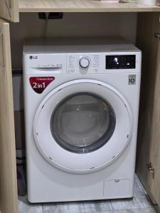 a white washing machine sitting in a cabinet at Smart Apartament in Brăila