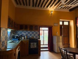 a kitchen with a stove and a table in a room at Utu house in Zanzibar City +5 photos