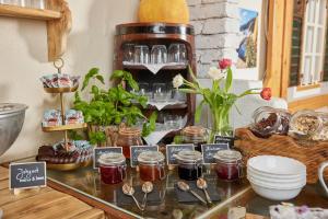 a counter with jars of jam and spoons at I AM HOTELS Graz-Seiersberg in Graz +66 photos