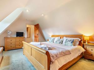 a bedroom with a bed with a dog laying on it at 1 Bed in Sherborne oc-93804 in Yetminster
