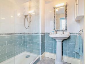 a bathroom with a sink and a mirror and a tub at 1 Bed in Sherborne oc-93804 in Yetminster +12 photos