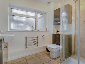 a bathroom with a toilet and a sink and a window at 3 Bed in Burnham-on-sea oc-92964 in Brean +11 photos