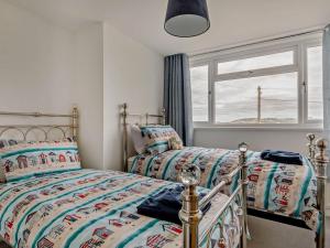 a bedroom with two beds and a window at 3 Bed in Burnham-on-sea oc-92964 in Brean