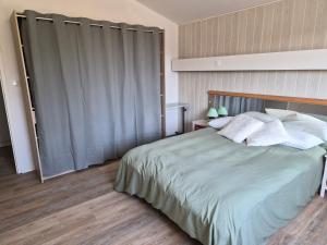 a bedroom with a large bed with white pillows at le coulinet in Andernos-les-Bains