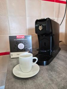 a coffee maker and a cup of coffee on a counter at le coulinet in Andernos-les-Bains