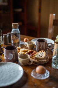 a table with plates and cups and food on it at Casa in Campagna Casagori in Pienza +3 photos