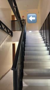 a staircase in a building with a sign on the wall at Hotel Estrela in Cruz Machado