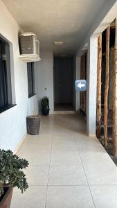 a hallway of a house with a tv on the wall at Hotel Estrela in Cruz Machado