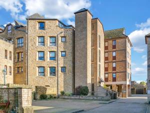 a large brick building with two tall towers at Central Sherborne in Sherborne