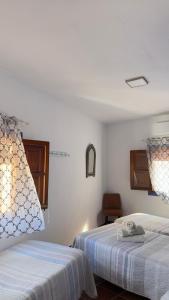a bedroom with two beds and a window at Casa Fina in Almuñécar