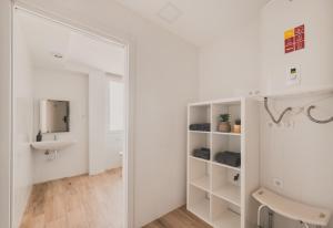 a white bathroom with a mirror and a sink at Alojamiento en Santa Eugenia A in Madrid +11 photos
