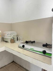 a white stove top oven sitting on a counter at Casa de Matilda in Silang