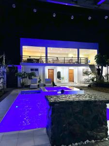 a house with a swimming pool at night at Casa de Matilda in Silang +7 photos