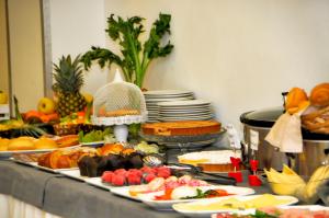 a buffet of food on a table with plates of food at Hotel Venezia in Caorle