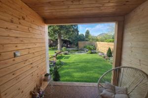 a screened in porch with a view of a yard at Bee house in Bořanovice