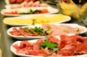 a row of plates of food on a table at Hotel Venezia in Caorle