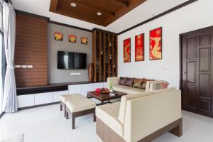 a living room with a couch and a table at The Best Ao Nang Villas in Ao Nang Beach