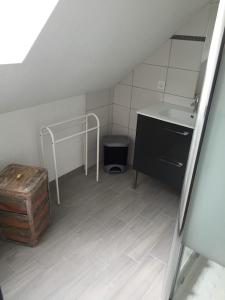 a bathroom with a sink and a table and a chest at Artouste in Laruns