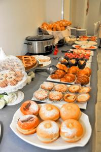 a buffet with many different types of donuts and pastries at Hotel Venezia in Caorle