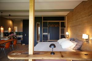 a bedroom with a bed and a table in a room at Domaine Aari Ona in Aramits +95 photos