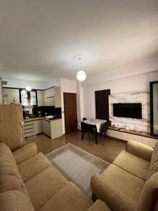a living room with a couch and a table at Kapo Apartments in Gjirokastër