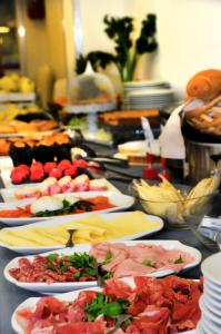 a table with many plates of food on it at Hotel Venezia in Caorle