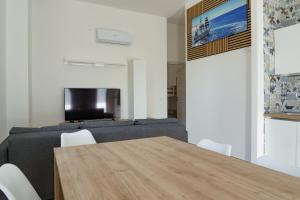 a living room with a wooden table and a couch at Costa d'Abruzzo - Casa Vacanza in Montesilvano
